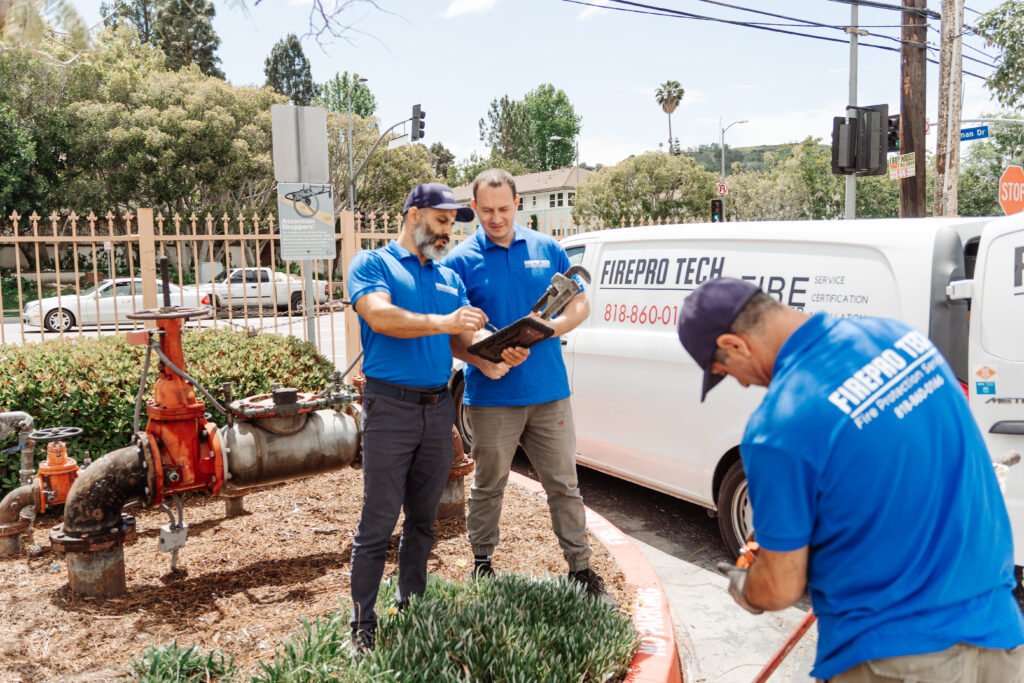 Technicians signing the Testing Fire Sprinkler Systems results