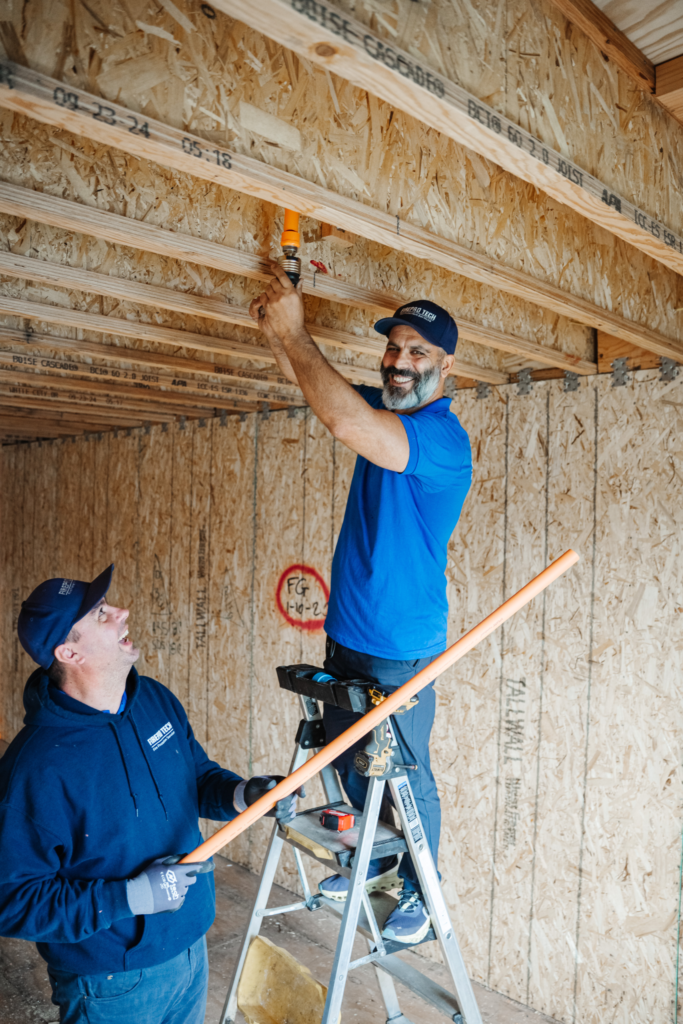 cost of fire sprinklers: two techs repairing a house