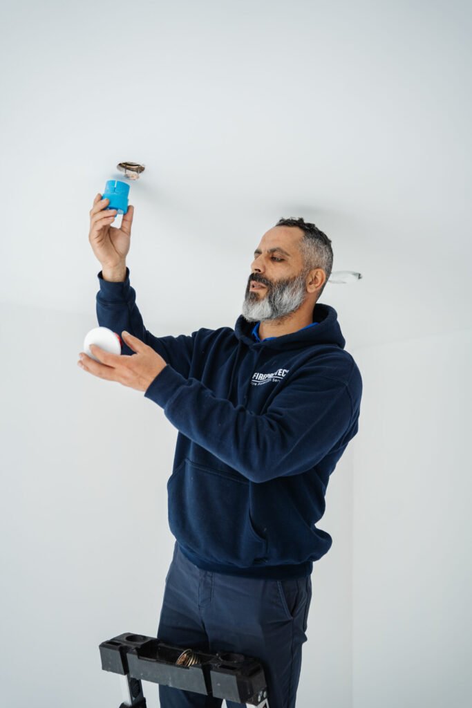 A technician looks for fire sprinkler corrosion signs