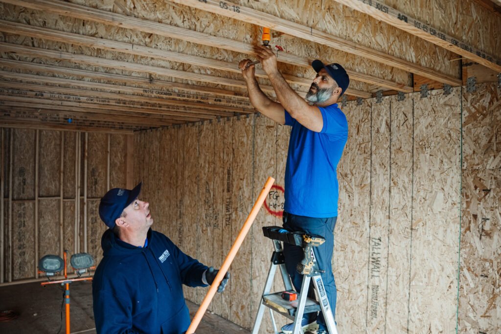 A team of professionals install a fire sprinkler corrosion protection