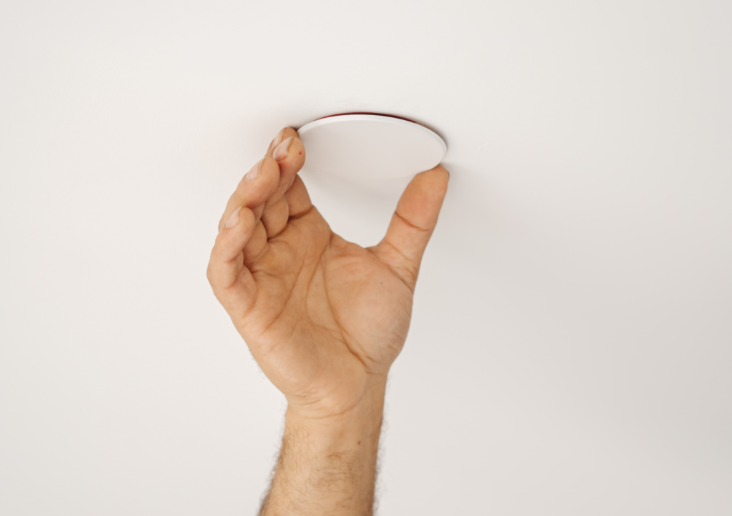 pendant fire sprinkler heads: a hand holsing a fire sprinkler